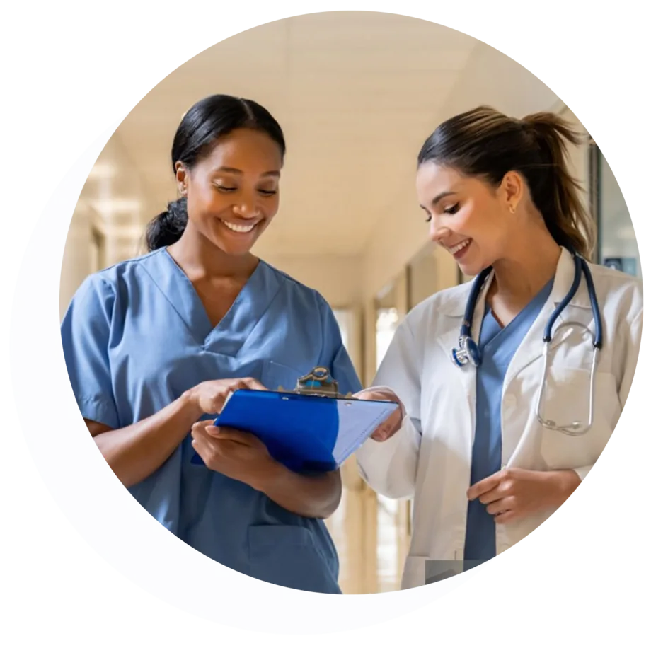 Two clinicians collaborating in a hospital corridor